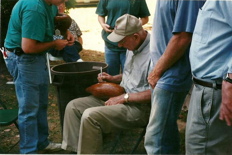 SL Bowman signing a decoy during an auction of his works, RL Fifield October 2001.