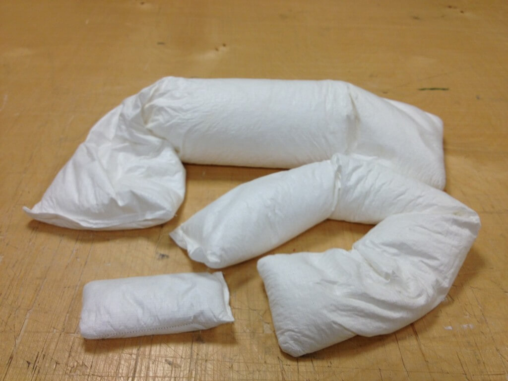 Tyvek pillows with (back to front) Ethafoam crumb, polypropylene bead, and glass sand filling. RL Fifield, 2012.